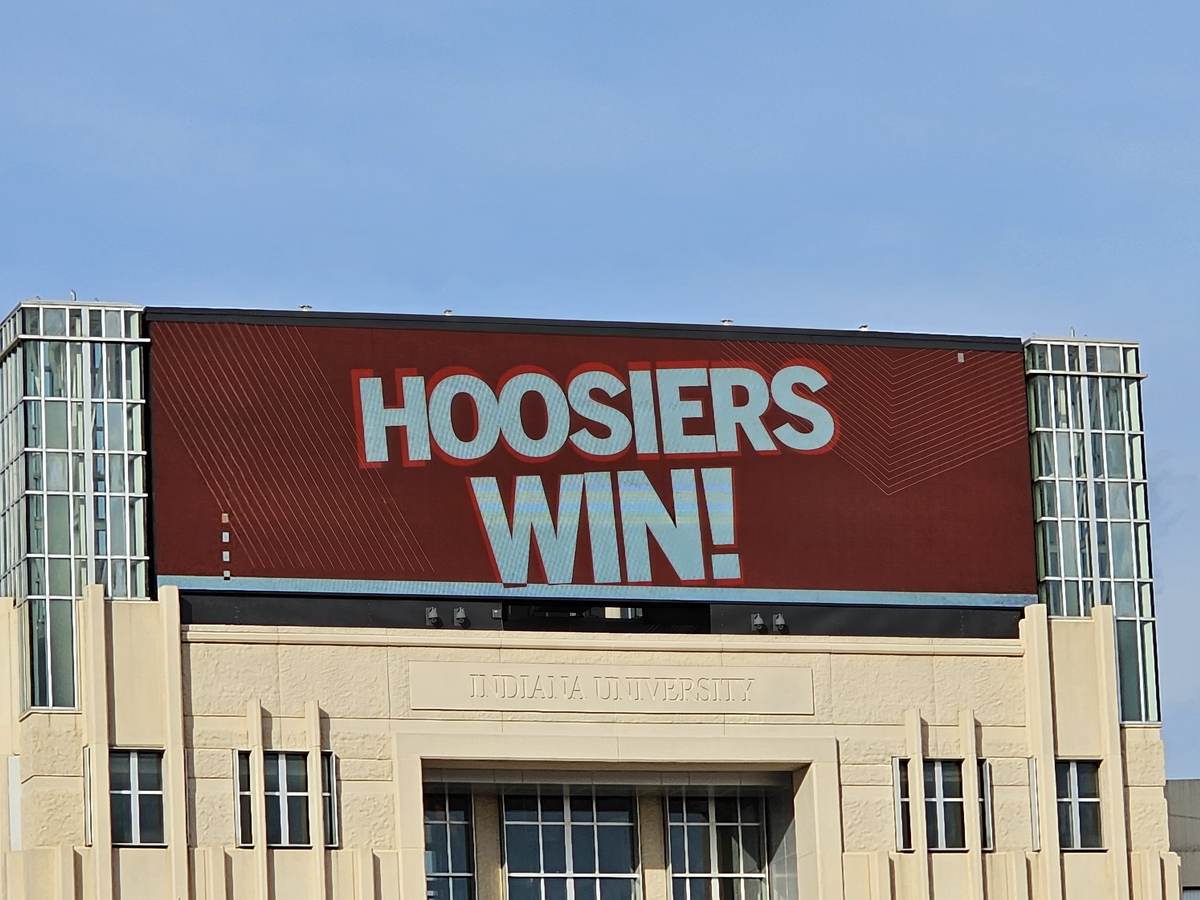 A large digital sign reading Hoosiers Win on the side of an Indiana University building in downtown Bloomington
