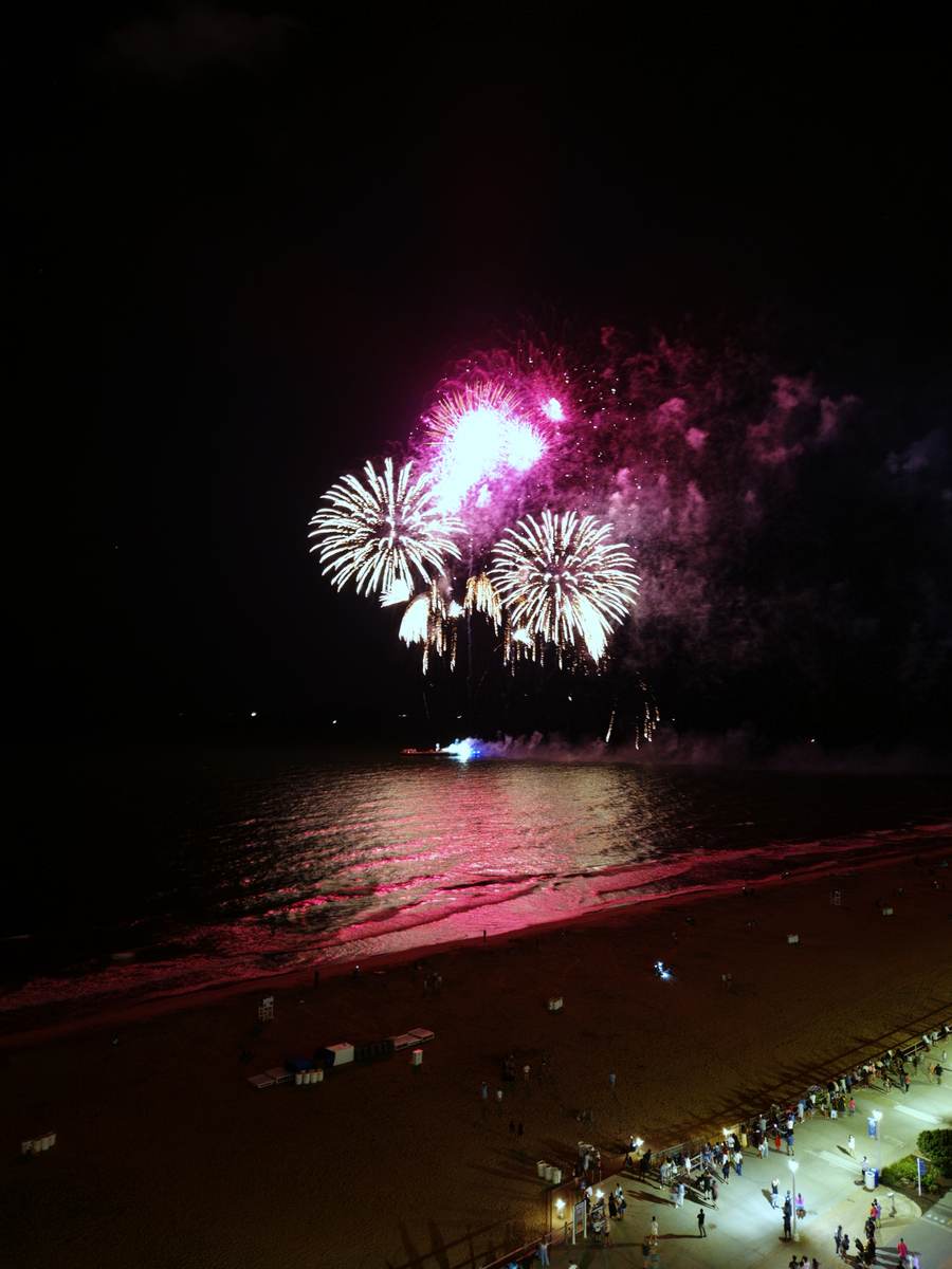 Fireworks over the ocean at Virginia Beach seen from a high-rise balcony