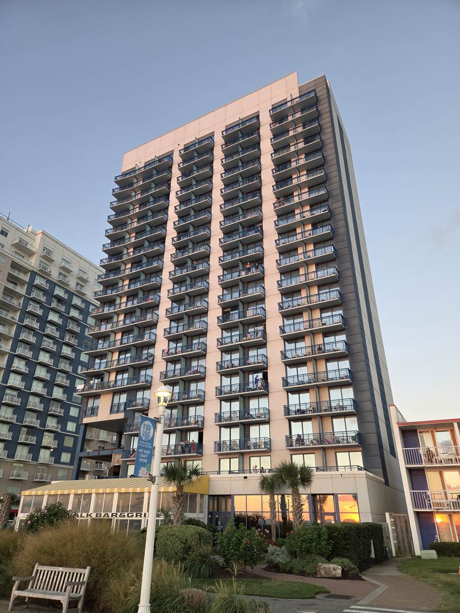 High-rise oceanfront hotel along the Virginia Beach boardwalk at dusk